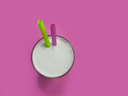 glass of milk, pipe on a colored backgroundの写真素材