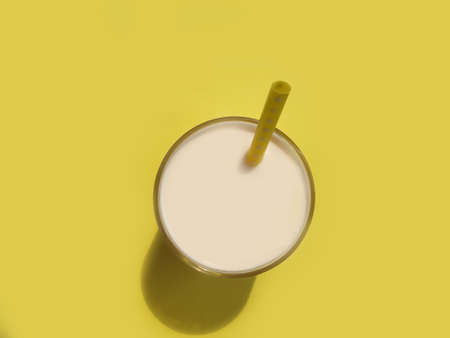 glass of milk, pipe on a colored backgroundの写真素材