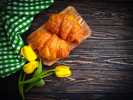 fresh croissant on wooden backgroundの写真素材