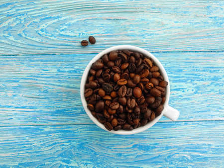 cup, coffee grain on wooden background