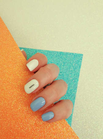 female hand beautiful  manicure on a colored background