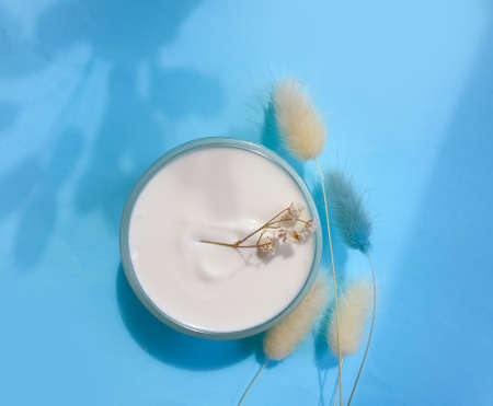 cream cosmetic flower on colored background