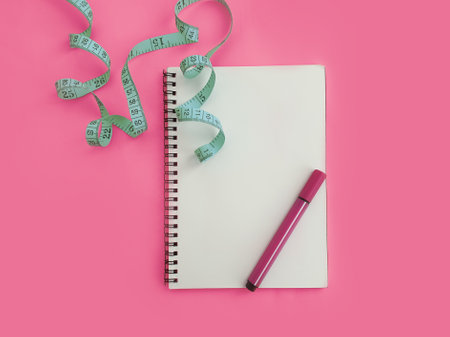 notebook, pen, measuring tape on a colored background