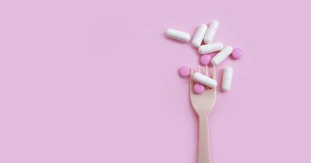 fork, pills on colored backgroundの写真素材