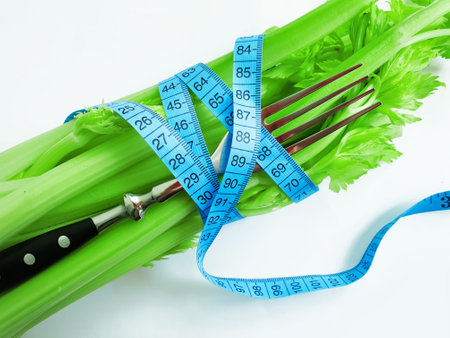 fresh celery measuring tape on white backgroundの写真素材