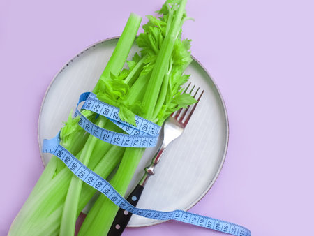 fresh celery measuring tape on white backgroundの写真素材