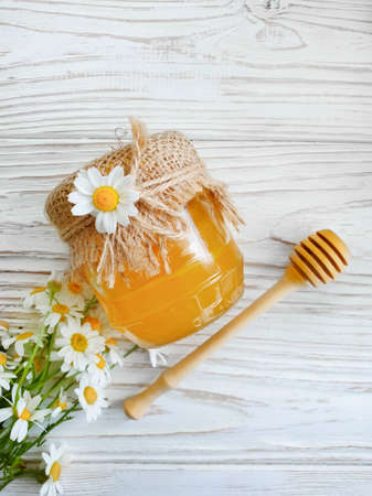 fresh honey chamomile flower on wooden backgroundの写真素材