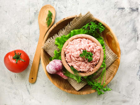 raw minced meat, parsley on a concrete backgroundの写真素材