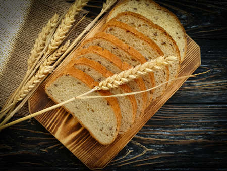 sliced â€‹â€‹bread, ear on a wooden background
