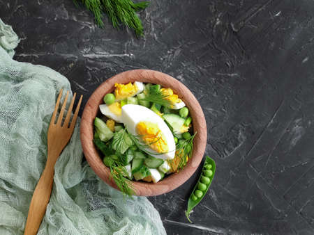 salad egg, cucumber, green peas on a concrete backgroundの写真素材