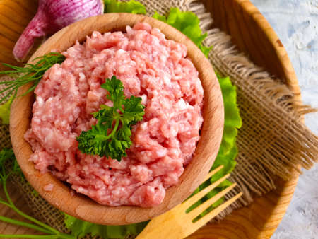 raw minced meat, parsley on a  backgroundの写真素材