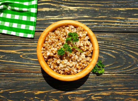 buckwheat porridge, parsley on a wooden backgroundの写真素材