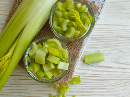 slices of fresh celery on wooden backgroundの写真素材