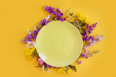 empty plate of flowers on a colored background