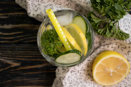 glass of water lemon, cucumber, parsley on wooden backgroundの写真素材