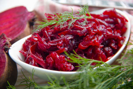 boiled grated beetroot on a wooden background