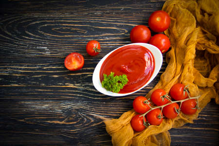 fresh ketchup, tomato on wooden backgroundの写真素材