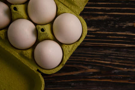 eggs in paper packaging on wooden backgroundの写真素材