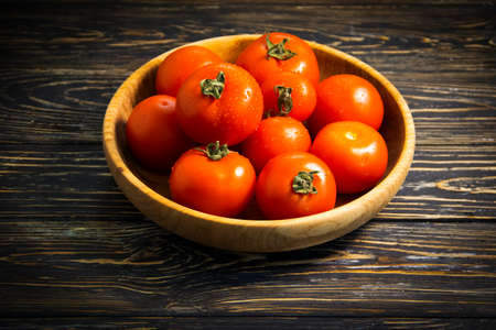 ripe tomatoes on wooden backgroundの写真素材