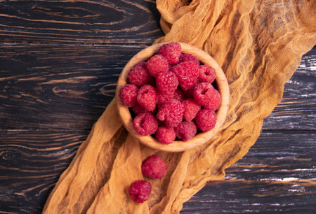 fresh raspberries on wooden background