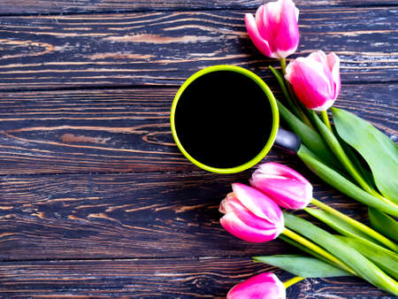 cup of coffee, flower tulip on wooden backgroundの写真素材