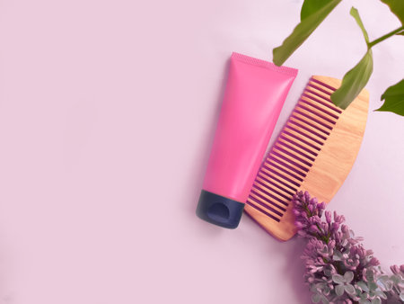 hair mask, wooden comb, lilac flower on a colored backgroundの写真素材