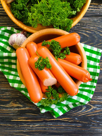 sausages, parsley on wooden backgroundの写真素材