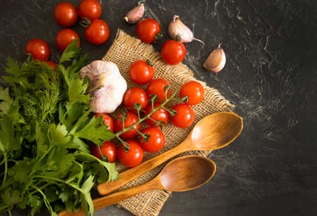 tomato, garlic, herbs on a concrete background