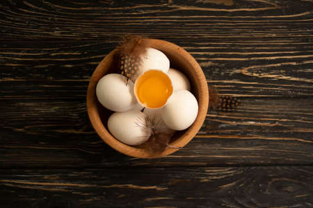 chicken eggs, feather on wooden background farmの写真素材