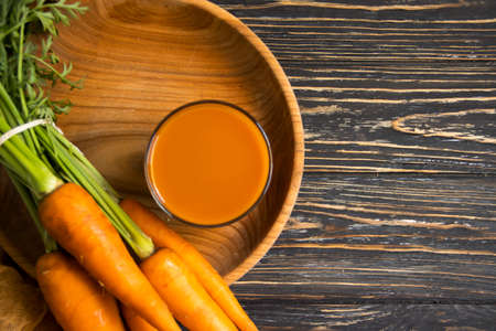 fresh carrot on a wooden background farm, vegetarianの写真素材