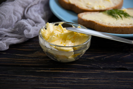 butter, bread, parsley on a wooden background