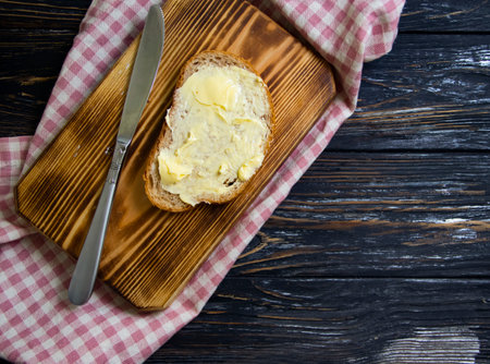 butter, bread, parsley on a wooden backgroundの写真素材