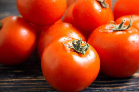 fresh tomatoes on wooden background ripe