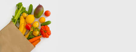paper bag, vegetables and fruits on a white backgroundの写真素材