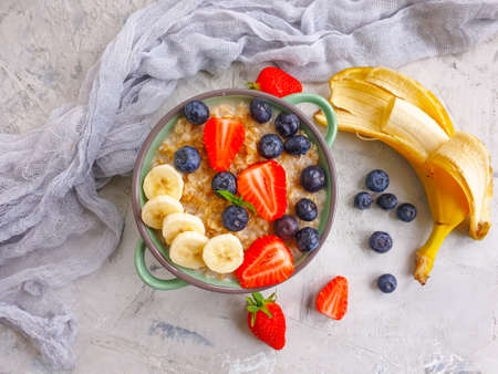 oatmeal, strawberry, blueberry, banana on concrete backgroundの写真素材