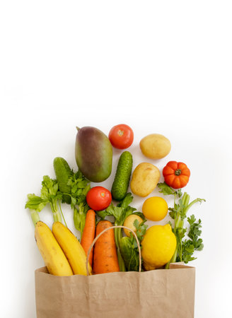 paper bag, vegetables and fruits on a white backgroundの写真素材