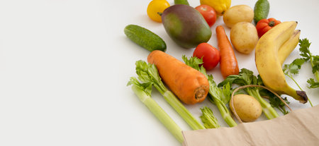 paper bag, vegetables and fruits on a white backgroundの写真素材
