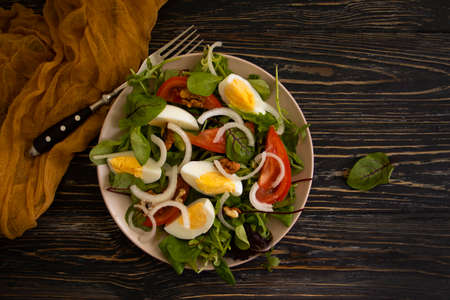 salad egg, tomato on wooden backgroundの写真素材
