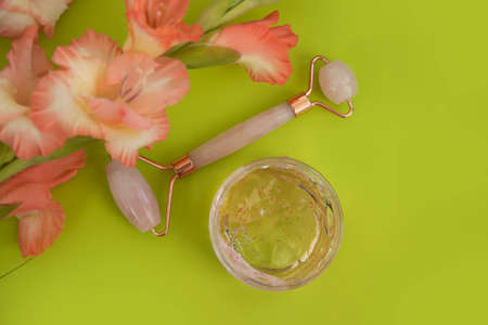 massage roller, flower on color background