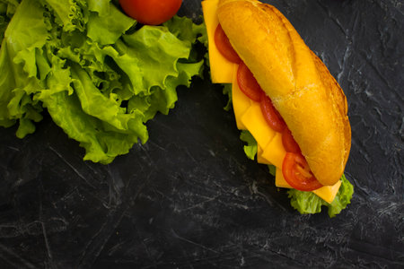 sandwich with cheese, tomato on a concrete background