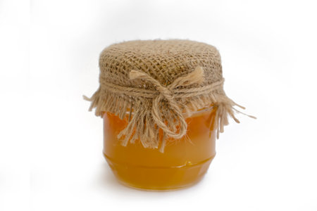 jar of honey isolated on white background