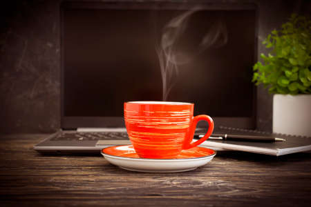 coffee cup, laptop on a wooden background, flowerpotの写真素材