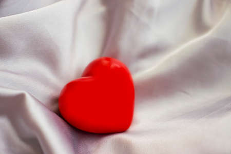 beautiful red heart on silk fabricの写真素材