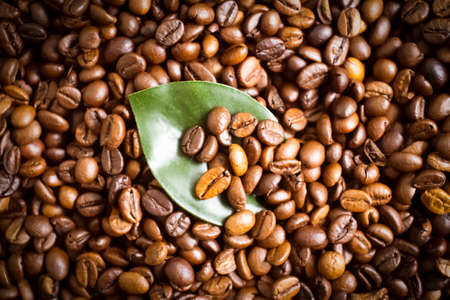 roasted coffee beans, leaf backgroundの写真素材