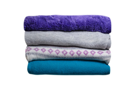 stack of folded warm clothes isolated on white background