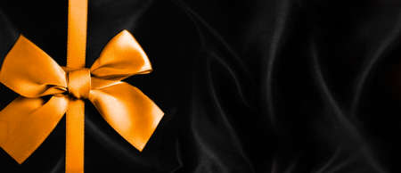 golden bow on black
 backgroundの写真素材