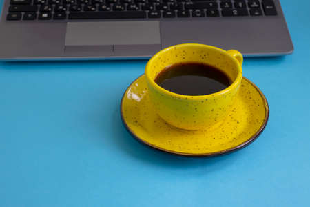 cup of coffee, laptop on a colored backgroundの写真素材