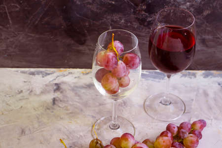 red wine glass, fresh grapes on concrete backgroundの写真素材