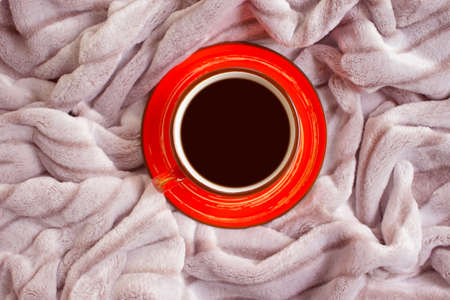 cup of coffee on a warm blanket