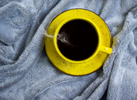 cup of coffee on a warm blanketの写真素材